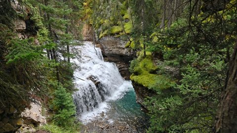 Johnston Canyon with waterfall flowing in deep forest at Banff national park, Canada