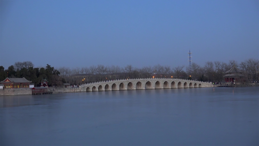 Iced  Kunming lake with the Seventeen-Arch Bridge at winter twilight. Summer Palace, Beijing, China.