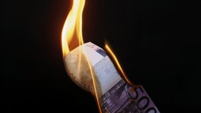 Burning of 500 euro banknote on black studio background. Flame of fire from a paper cash. Financial crisis and depressed economy. Paper money loss concept.  - Powered by Shutterstock - Get 15% off with code: PIKWIZARD15