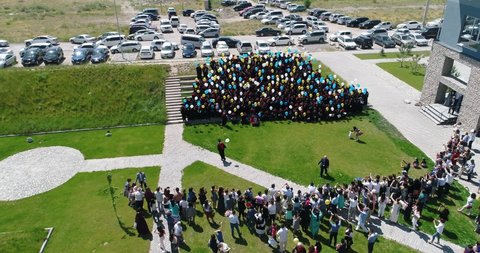 Bishkek, Kyrgyzstan - June 2, 2019: Aerial view of university graduates standing on the stairs. Commencement ceremony of the American University of Central Asia in Bishkek city, Kyrgyzstan