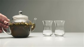 Video of pouring nice tasty herbal tea in turkish glasses