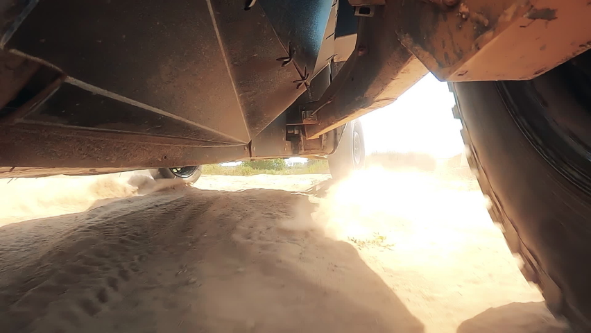 Bottom view of a racing vehicle riding through terrain