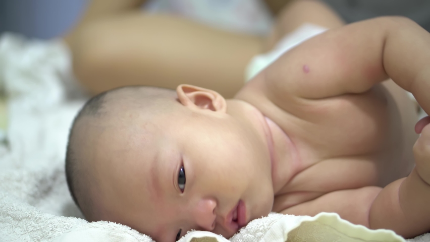 Close up bald baby boy learn and try to roll over