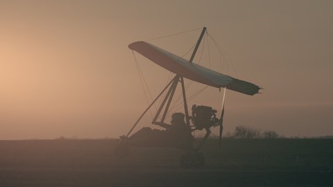 The testing flights by hang glider on the sunset background