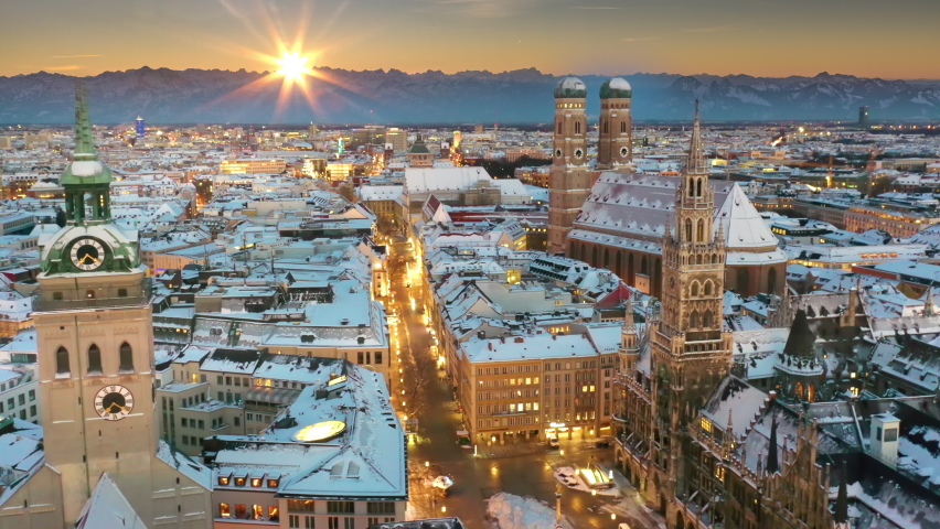Munich marienplatz sqaure aerial view drone footage in 4k. Munich skyline, munich winter city cowered with snow at sunset pre alps mountains, frauenkirche church, cathedral town hall. Royalty-Free Stock Footage #1082668057