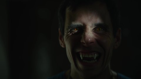 Vampire bares his teeth in the dark