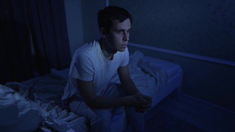 Man having depression sitting on the bed