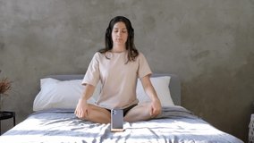 Young woman practicing yoga breathing with trainer by videoconference. Concept of relaxation, stress relief and harmony.