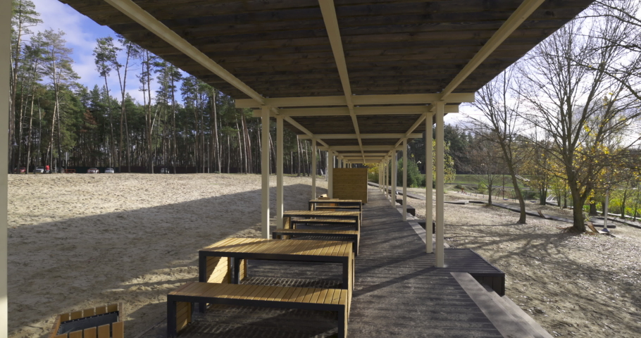 Wooden bridge in the park on coast with relaxation view, slow motion 60 fps. Wooden construction, architecture on park.