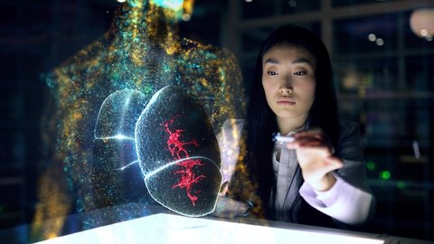 Asian woman Scientist analyses patient lungs and health indicators using augmented reality. Doctor work on 3D Simulated holographic lungs. Virus Detection 3d Animation. Artificial Intelligence Concept