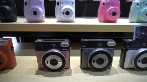 Yogyakarta, Indonesia - November 19, 2021: Rows of instant cameras (polaroids) that can process their own photos inside the camera body after shooting. Fujifilm.