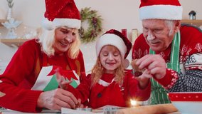 Caucasian senior family couple grandmother grandfather with granddaughter preparing, cooking homemade cookie play game with dough figurines at home Christmas kitchen. Xmas New Year holiday celebration - Powered by Shutterstock - Get 15% off with code: PIKWIZARD15