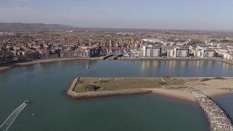 Aerial footage of the lock entrance to Sovereign Harbour in Eastbourne with boats heading towards the Marina.