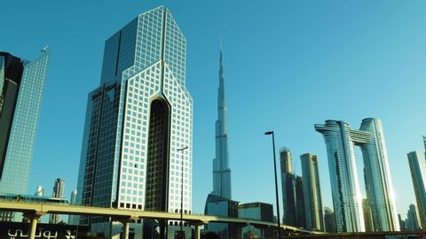 Dubai, United Arab Emirates - November 14, 2021: Beautiful view of Dubai city skyscrapers or skyline along with Burj khalifa. Dubai RTA Metro rail passing through. A view from Sheikh Zayed Road Dubai