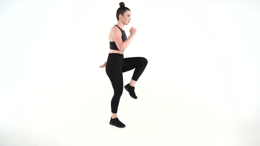 Certified female fitness trainer executes bodyweight exercise on a white background . Upper body Lower body Total Body Exercises for beginners intermediate advanced  levels | Shutterstock HD Video #1082685406