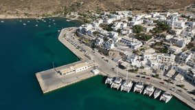 Aerial drone video of Adamantas - picturesque main port of Milos island a safe natural yacht and sailboat anchorage protected by winds, Cyclades, Greece