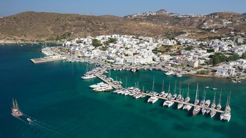 Aerial drone video of Adamantas - picturesque main port of Milos island a safe natural yacht and sailboat anchorage protected by winds, Cyclades, Greece