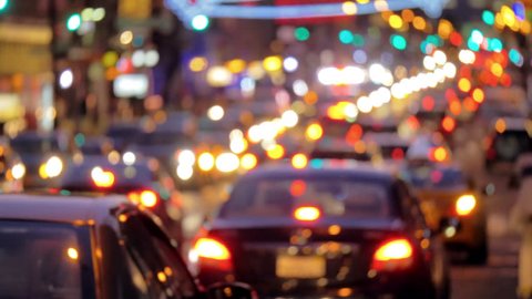 Defocused busy street traffic in New York City at night 