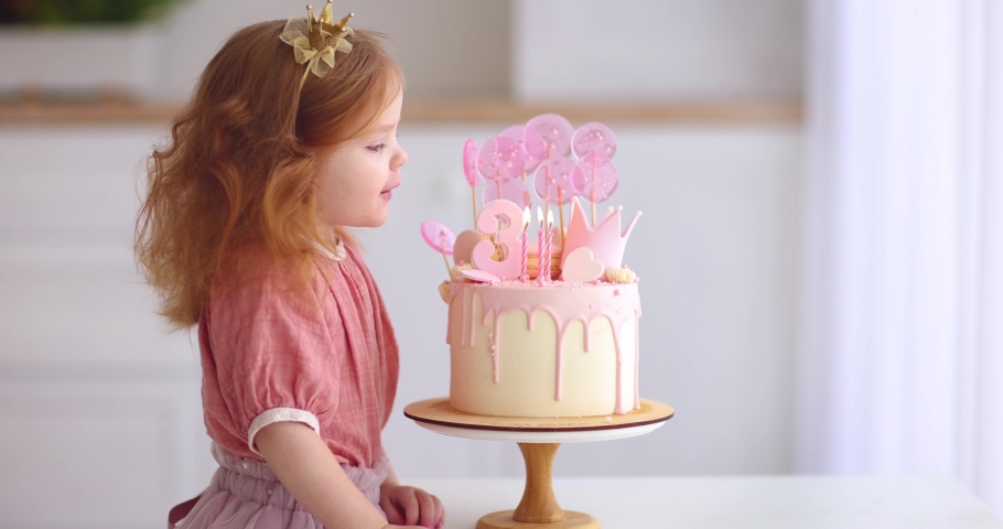 cute baby girl blowing the candlles on birthday cake. three years old Royalty-Free Stock Footage #1082698909