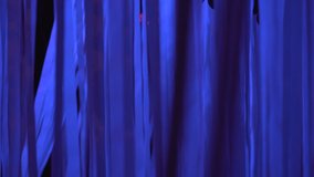 White ribbons sway in the wind in blue neon light on a dark night, nightclub decorations, abstract background, modern art, installation, bright neon light, beautiful texture, 4K video - Powered by Shutterstock - Get 15% off with code: PIKWIZARD15