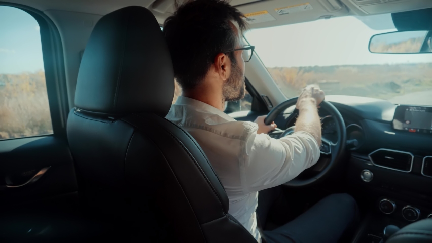 Car Driver Hold Steering Wheel Enjoy Traveling Road Route. Confident Driver Driving Expensive Car. Joyful Driver Turning Steering Wheel In Luxurious Auto Car On Trip. Driver Guy Driving SUV Automobile Royalty-Free Stock Footage #1082707972