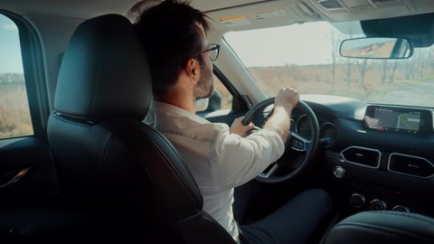 Car Owner Hold Steering Wheel Enjoy Traveling Road Route. Confident Businessman Driving Expensive Car. Joyful Driver Turning Steering Wheel In Luxurious Auto On Trip. Happy Guy Driving SUV Automobile