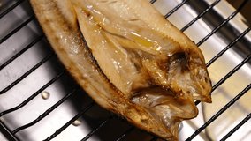 Big and delicious atka mackerel. A close-up video of grilling atka mackerel.