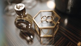 There are two gold wedding rings on a glass casket. Shooting beautiful objects - Powered by Shutterstock - Get 15% off with code: PIKWIZARD15