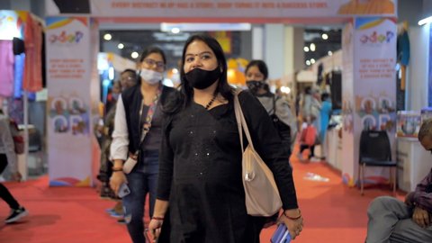 Pragati Maidan, New Delhi, India, 17th November 2021, Timelapse shot of people attending the exhibition wearing masks. Wide shot of an exhibition hall - trade fair in Delhi