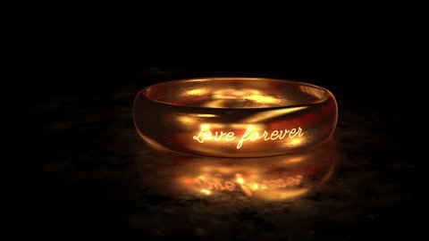 Flying around the gold ring LOVE FOREVER on the matte glass surface with reflection