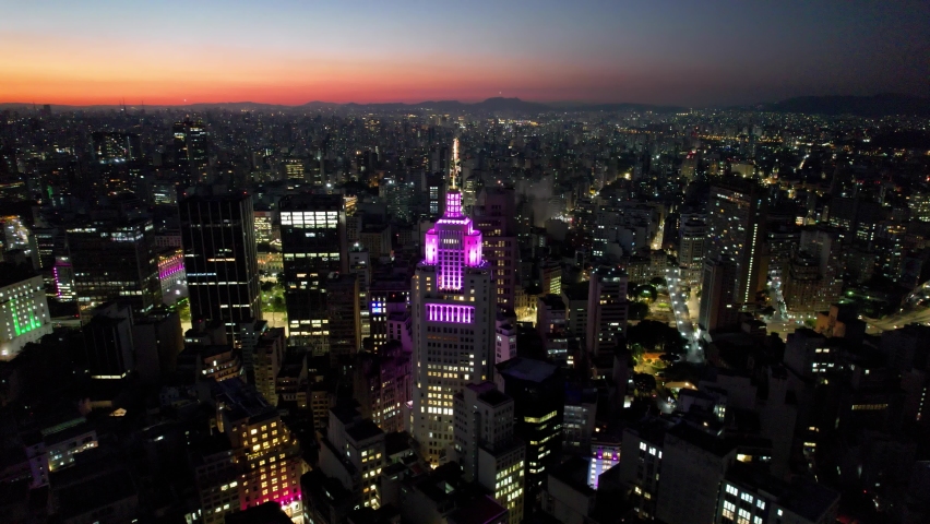 Sunset at downtown Sao Paulo. Sao Joao avenue. Urban aerials. Night life at downtown district of Sao Paulo, Brazil. Illumination building and street of downtown city. Altino Arantes building sunset.
