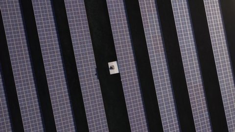 topdown aerial shot over a field of solar panels in the Netherlands. A lot of solar energy will be produced by this sustainable solution. Durability and innovation. Zoom out. 4K 30FPS