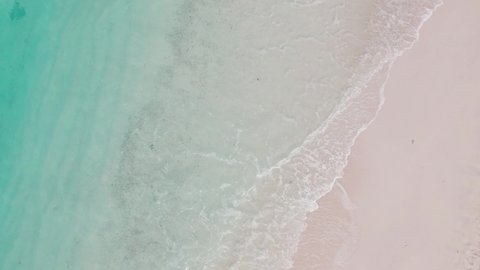 Aerial shot of sandy beach and indian ocean in Maldives, gimbal shot of shore and waves. Tropical island with no people, uninhabited place. Concept of tourism