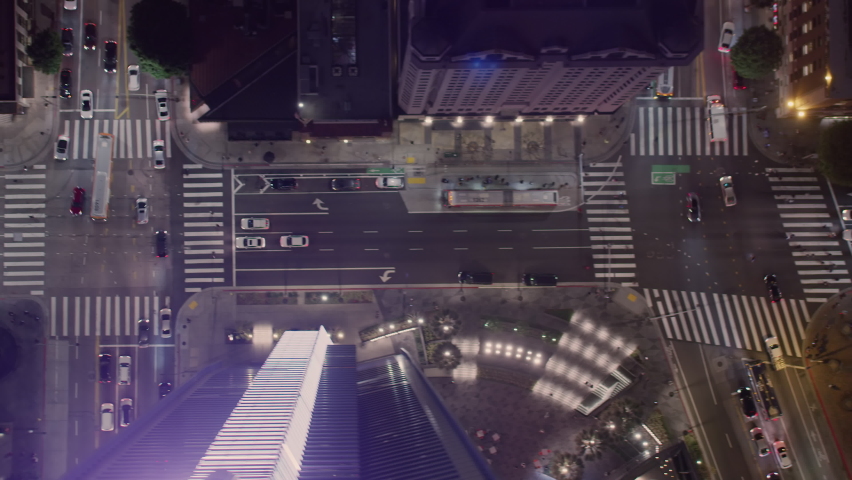 Looking Straight Down on City Streets with Traffic. Over Head Aerial View of Several Buildings And Street Intersections In Downtown Los Angeles at night. People walking.