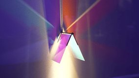 This video shows a colorful light refraction apparatus with geometric reflections in multiple colors and lights.