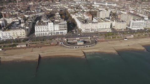 Aerial footage of Eastbourne Bandstand and Seafront by Grand Parade with Devonshire Place leading away behind the Bandstand. 