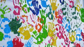 human colored palms. Colored handprints. close-up. art. many colored prints of human palms on a white background, on a white wall or canvas - Powered by Shutterstock - Get 15% off with code: PIKWIZARD15