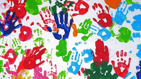 human colored palms. Colored handprints. close-up. art. many colored prints of human palms on a white background, on a white wall or canvas