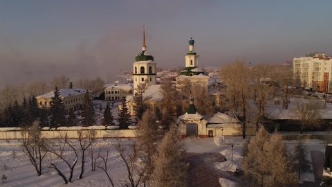 Russia, Irkutsk - January 20, 2021; Znamensky Convent in Irkutsk. Aerial drone flight. Tourist hotels and restaurants. In winter, the Russian city is covered with ice and snow.