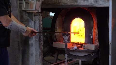 Murano, Venice,Italy November 2021 : Making famous Venetian glass in Murano, glass making - actual process inside the factory in Venice - high temperature furnace oven with fire  for melting