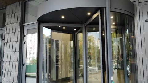 A revolving door in modern buildings and shopping centers to the Mall. Glass rotating door. Turntable entrance to the business center.
