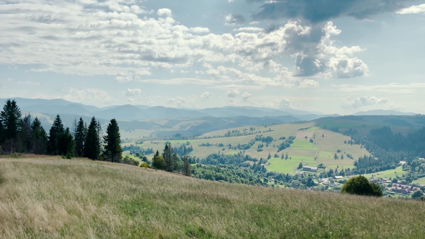 Panorama of mountain landscapes with green hills on a sunny day | Shutterstock HD Video #1082751529