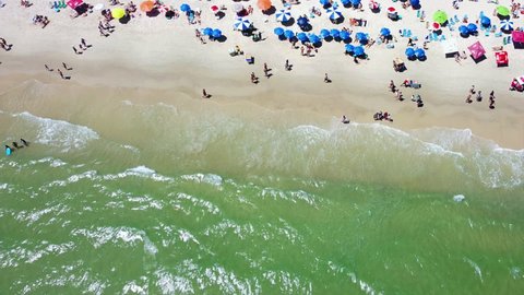 Crowd of people at Jurere Internacional Beach located in the north of the island, Florianopolis, Santa Catarina