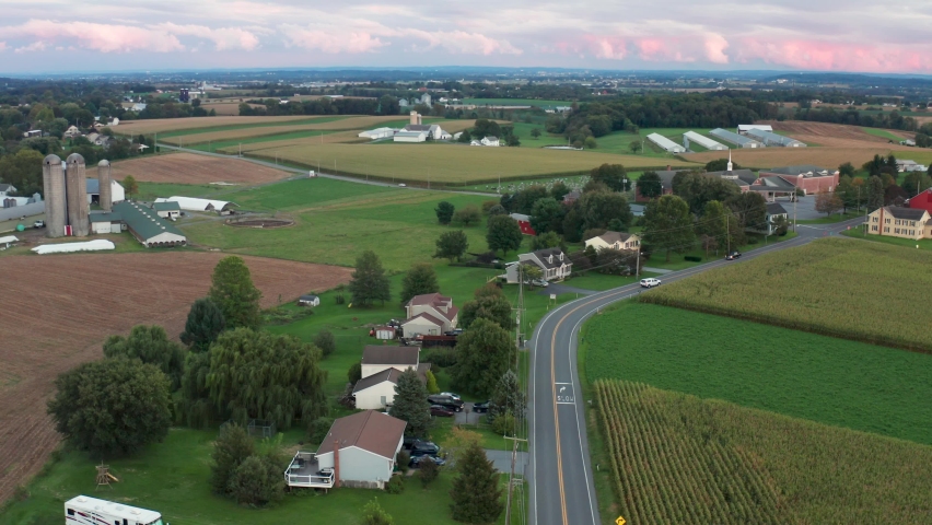Aerial of rural community in USA. Beautiful colorful farm fields. Agriculture and life in small town America. Royalty-Free Stock Footage #1082765482