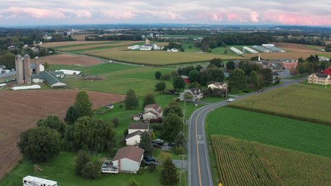 Aerial of rural community in USA. Beautiful colorful farm fields. Agriculture and life in small town America.