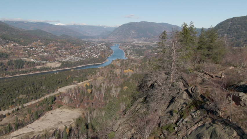 Aerial parallax rotation around cliff in British Columbia with river in the background