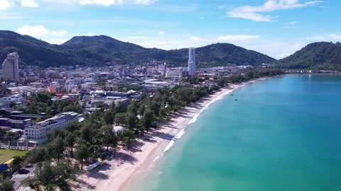 Top view drone shots sea and sand beach on a summer day. 4K Aerial view popular beach famous tourist Kamala Beach in Phuket, Thailand. waves breaking to sand for long beach sunset.no people.