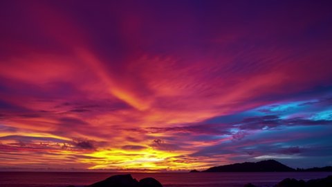 Timelapse of Amazing dramatic sunrise sky or sunset sky and clouds flowing over tropical sea
