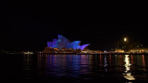 SYDNEY, NSW, AUSTRALIA. JUNE 11 2019. Vivid lights on Sydney Opera House, tracking shot.