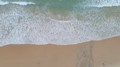 Beautiful tropical beach footage Amazing Sandy coastline with white turquoise sea waves. Beautiful Aerial view of white sand beach and water surface texture, foamy waves at Karon beach Phuket Thailand